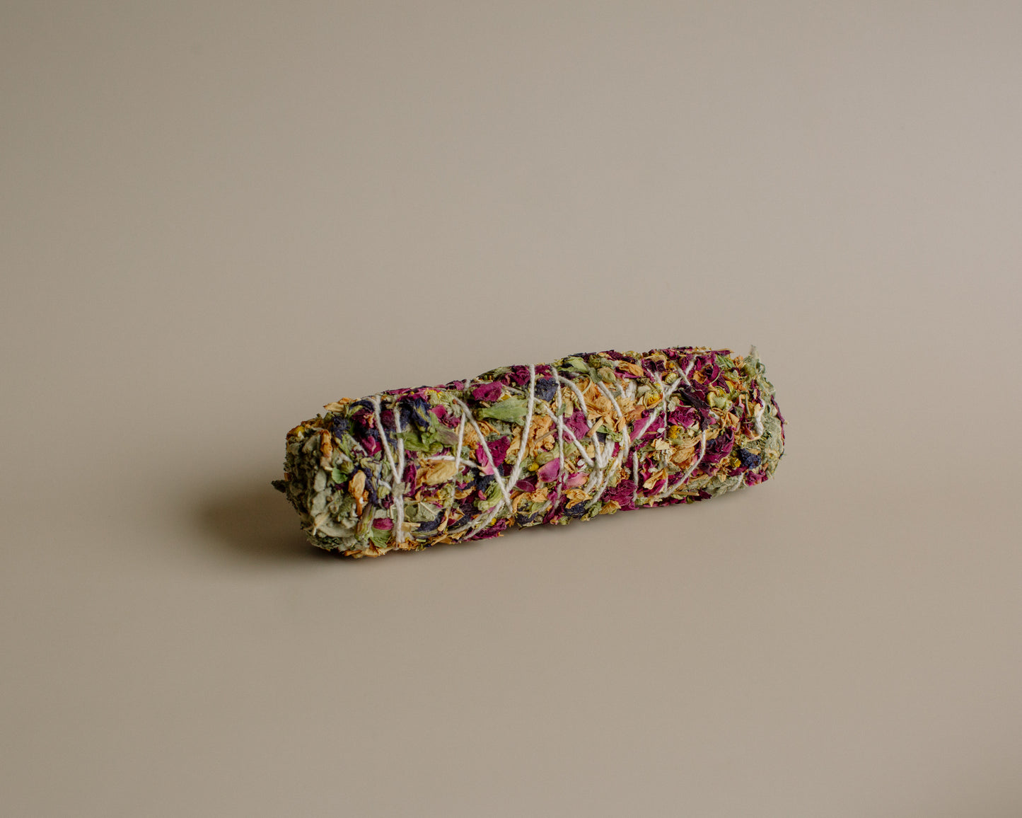 Colorful rolled herbal smoke sticks on a beige background