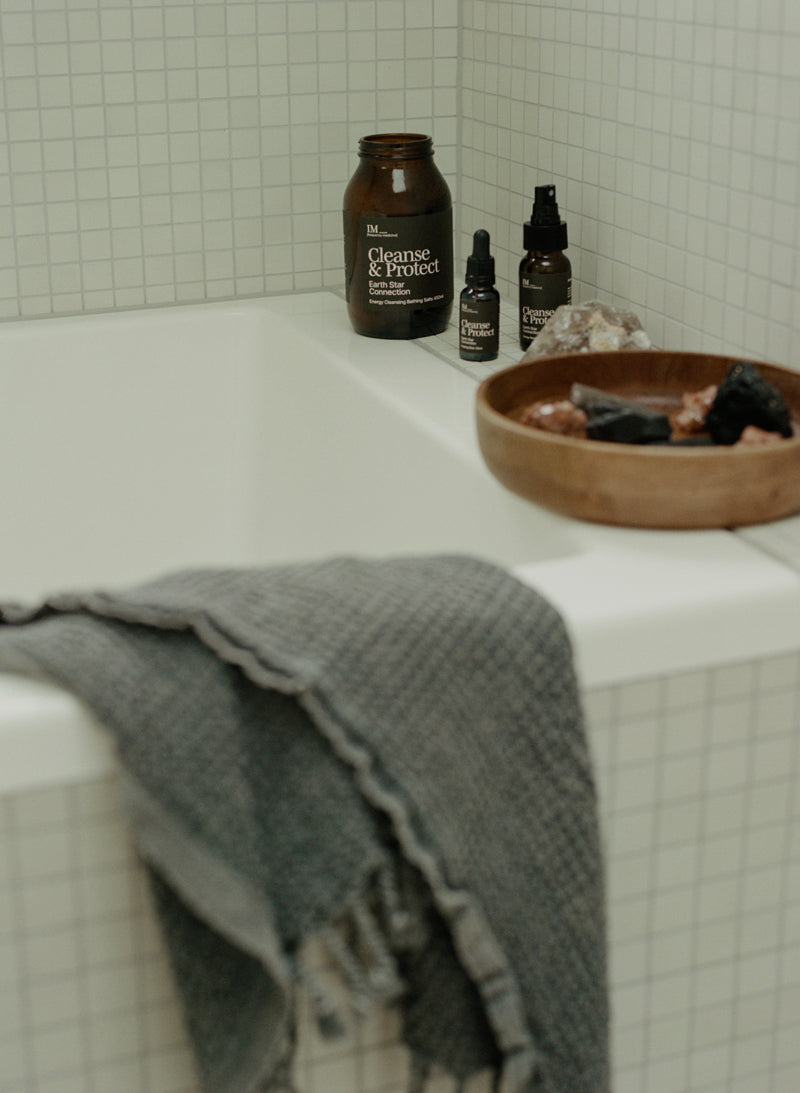 IM_Cleanse_Protect_Family of protect on bath side with smokey quartz crystals and raw crystals in wooden dish and towel