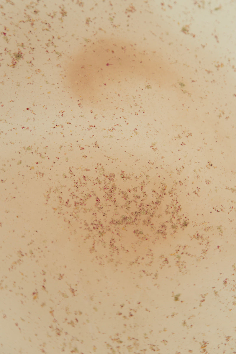 IM_Frequency_Medicine_Embody_Bathsalts in water -- peach/orange flecks
