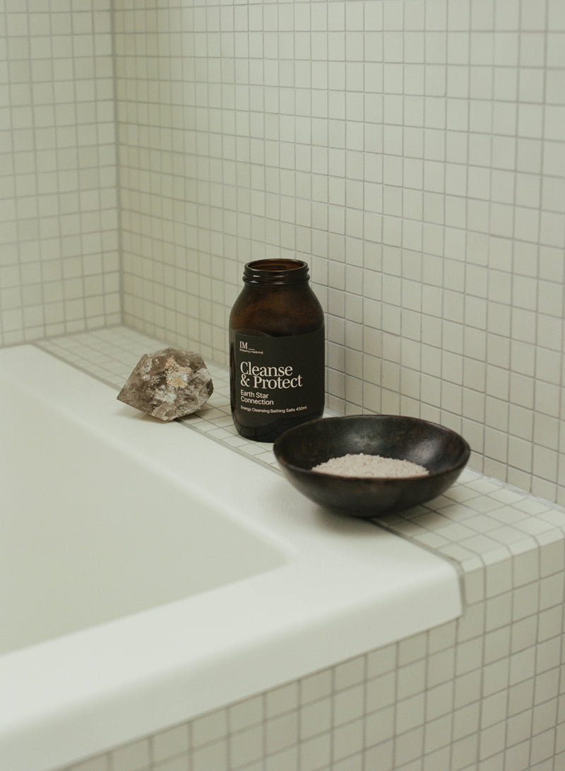 Cleanse and protect IM Frequency Medcine bath salts jar on tiled bath with large smokey quartz crystal and bowl of salts 