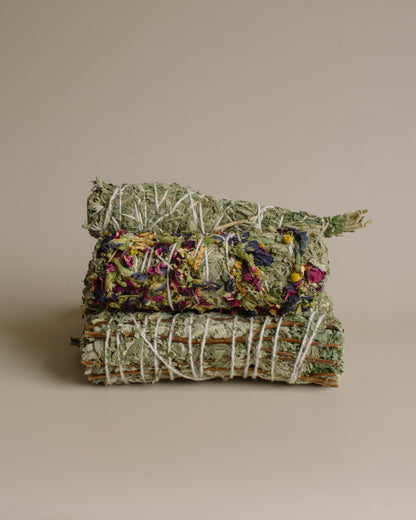 Stack of dried herbs tied together on a beige background