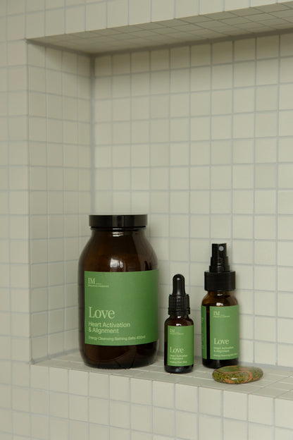 IM_frequency_medicine_Love_healing_elixir, bahtsalts and spray bottles with green lables. Unakite stone. inside tiled bathroom shelve